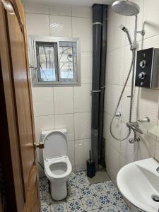 a bathroom with a toilet and a sink at Tapoko residence in Yaoundé