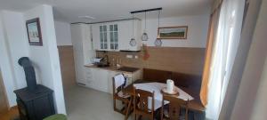 a small kitchen with a table and a stove at Peace & green in Žabljak