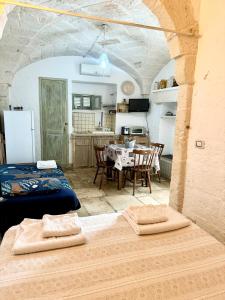 a room with a kitchen and a table with chairs at La Casetta - Typical Guest House in Fasano