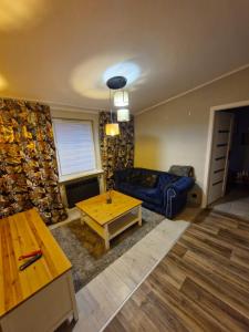 a living room with a blue couch and a table at Apartament Starołeka in Poznań