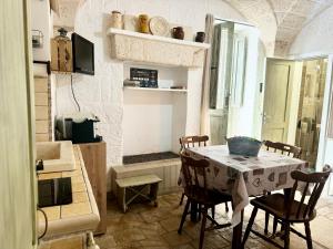 a kitchen with a table and chairs in a room at La Casetta - Typical Guest House in Fasano