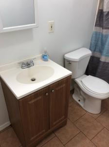a bathroom with a sink and a toilet at Large and private apartment in convenient area sleeps up to 5 people comfortably in Elizabeth