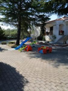 a playground with a slide and play equipment in a yard at Appartamento Ceschini in Vieste
