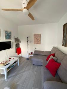 a living room with a couch and a ceiling fan at El Mirador de Pablo in Alcalá de los Gazules
