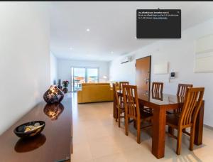 a dining room and living room with a table and chairs at G at Bela Baia Salir in Salir de Porto