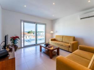a living room with a couch and a table at G at Bela Baia Salir in Salir de Porto