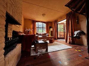 a living room with a couch and a fireplace at Het Boshoekje Bosweg 6 Burgh-Haamstede in Burgh Haamstede