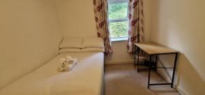 a small room with a bed with a window at Tidy Spacious & Quiet 2BD on Edge of Cork City in Cork