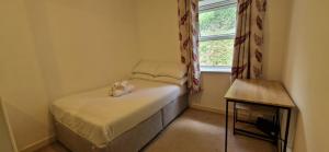 a small room with a small bed with a window at Tidy Spacious & Quiet 2BD on Edge of Cork City in Cork