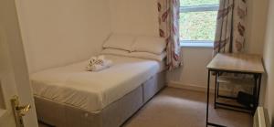 a small room with a bed with two stuffed animals on it at Tidy Spacious & Quiet 2BD on Edge of Cork City in Cork