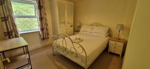 a bedroom with a white bed and a window at Tidy Spacious & Quiet 2BD on Edge of Cork City in Cork