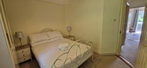 a bedroom with a bed with white sheets and pillows at Tidy Spacious & Quiet 2BD on Edge of Cork City in Cork