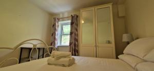 a bedroom with a bed and a window at Tidy Spacious & Quiet 2BD on Edge of Cork City in Cork