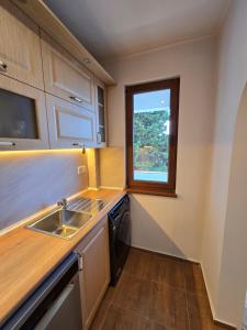 a small kitchen with a sink and a window at Super Lovely Apartment in Burgas