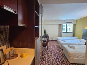 A bed or beds in a room at Kota Kinabalu City Ensuite at SCSP Ming Garden