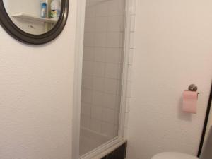a bathroom with a shower and a toilet with a mirror at Maison 2 Pièces Mezzanine Proche Plage, Animaux Acceptés, Parking - FR-1-229D-55 in Fleury +7 photos