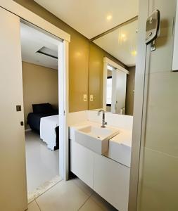 a bathroom with two sinks and a mirror at Apto 2 suítes - Umarizal in Curro Velho