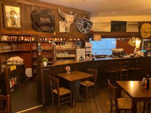 a restaurant with a table and a bar at Agriturismo al Ranch in Castello dʼAviano