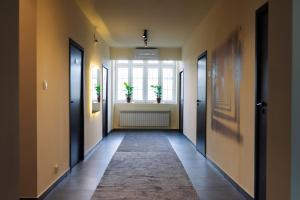 a hallway with two doors and a window at Boutique-Capsule Hostel in Warsaw