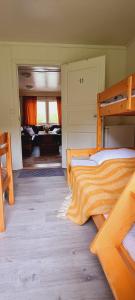 a bedroom with two bunk beds and a piano at Romsdalseggen Camping in Isfjorden