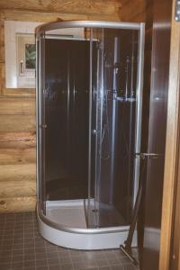 a shower in a kitchen with a black refrigerator at Järve Holiday Village in Kodavere
