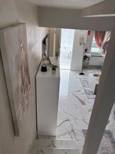 a hallway with a marble floor and a white counter at La pulga en el océano in Torrelavega +17 photos