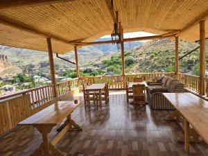 a living room with tables and a view of a mountain at NUR TOON in Areni