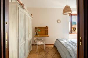 a bedroom with a bed and a chair in it at La Casa nel Borgo in San Felice del Benaco