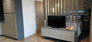 a living room with a tv on a cabinet at Alanga in Palanga