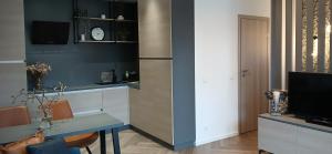 a kitchen with a table and a refrigerator at Alanga in Palanga +11 photos