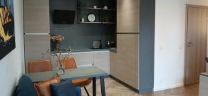 a kitchen with a table and chairs and a refrigerator at Alanga in Palanga