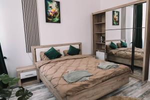 a bedroom with two beds with green pillows at Casa Alecsandri -Ultra Central in Oradea