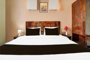 Säng eller sängar i ett rum på Hotel Palm Tree