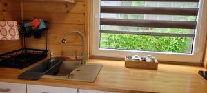 a kitchen counter with a sink and a window at Niebieski Zakątek in Wisełka +60 photos