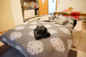 a bed with black shoes on top of it at House 416 Sweet Apartment in Perugia