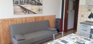 a living room with a couch and a table at Casa Quokka in Meana di Susa +22 photos