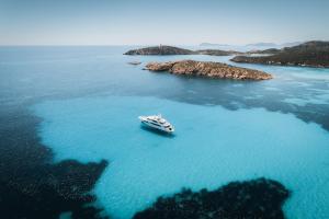an aerial view of a boat in the water at Casa Il Nido, 250m to beach in Fort Village