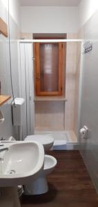 a bathroom with a toilet and a sink and a shower at Casa Quokka in Meana di Susa