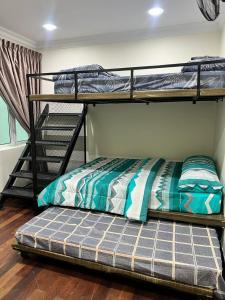 a bedroom with two bunk beds and a bed at Mossy Green Golfcourse Homestay in Tanah Rata