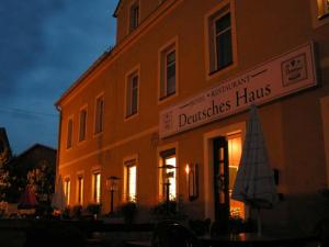a building with a sign on the side of it at Hotel Deutsches Haus in Kurort Gohrisch