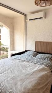 a bedroom with a bed with a large window at Beach cabin studio in Argelès-sur-Mer