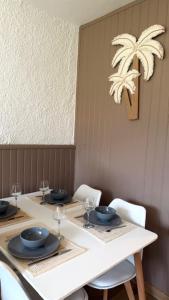 a table with bowls and plates on top of it at Beach cabin studio in Argelès-sur-Mer +15 photos