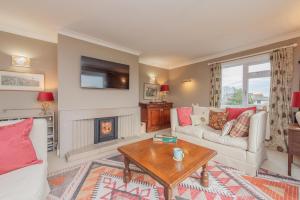 a living room with a couch and a fireplace at Pear Tree Cottage in Shrewsbury