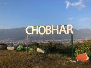 a sign that reads chobiar on top of a hill at Kathmandu Family Home in Kirtipur