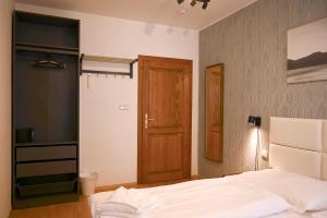 a bedroom with a bed and a wooden door at Villa Margarita in Český Krumlov