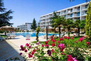 a resort with a swimming pool and pink flowers at Atlantis Getaway in Burgas City