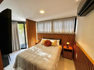 a bedroom with a bed with a teddy bear on it at Loft para Casal em Bombinhas - Sem Garagem in Bombinhas
