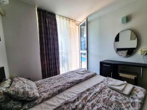 a bedroom with a bed and a large window at Atlantis Getaway in Burgas City +18 photos