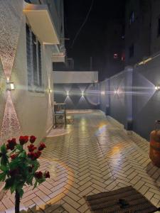 a patio at night with a vase of flowers and lights at Swarajya Homestay in Aurangabad