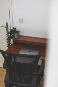 a desk with a laptop computer on top of it at Spacious Wembley Flat Comfy Beds 2 Baths in London +27 photos